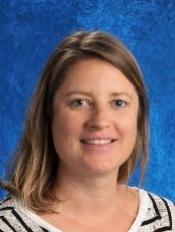 Portrait of a woman with shoulder-length hair, wearing a striped shirt, against a blue background.